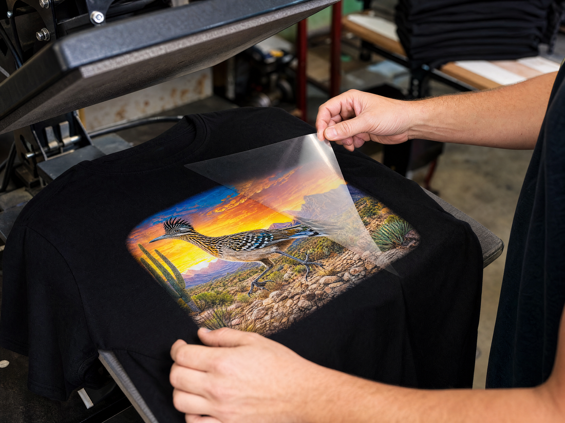 High-resolution DTF transfer being heat-applied to a black T-shirt